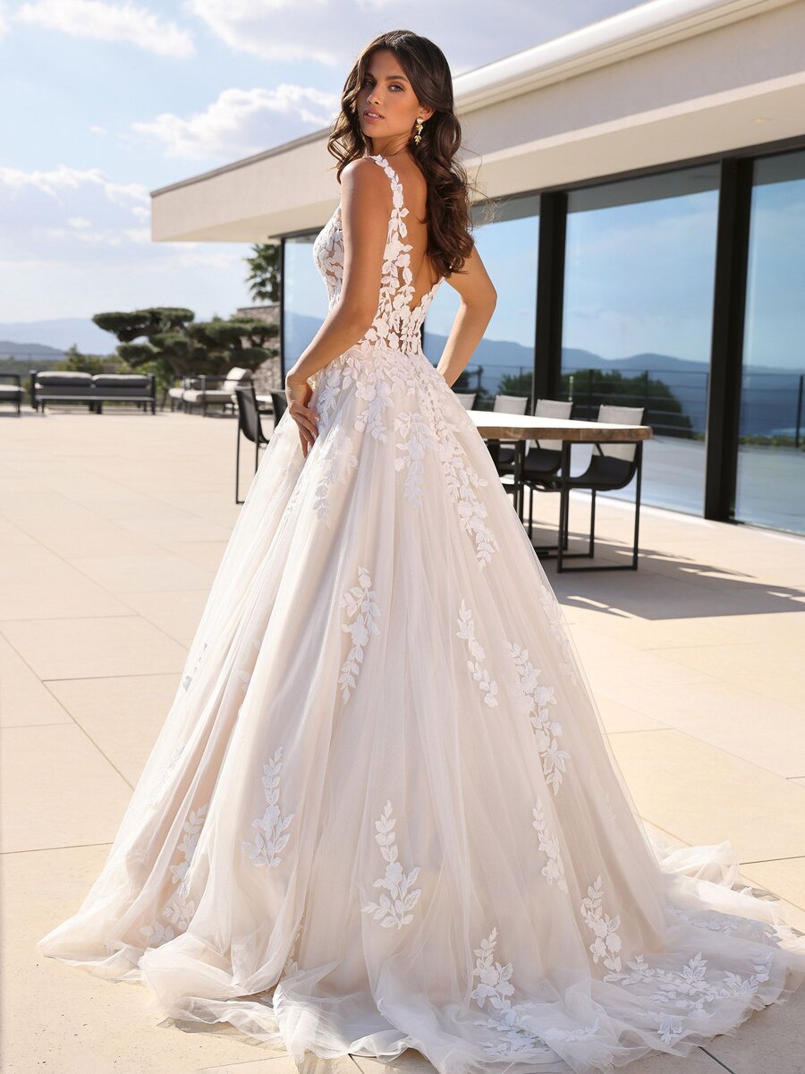 Jubilee wedding dress by Ladybird Bridal featuring a sheer lace appliquรฉ bodice, V-neckline, and flowing tulle A-line skirt.