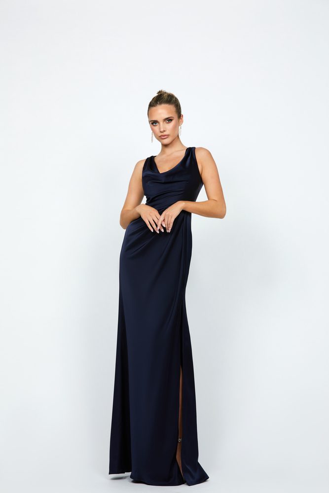 Adelynn Cowl Neck Gown BL74D65L by Bariano in Navy drape satin. Features a V-cowl neckline, wide straps, tapered waistline, draped maxi skirt with side split