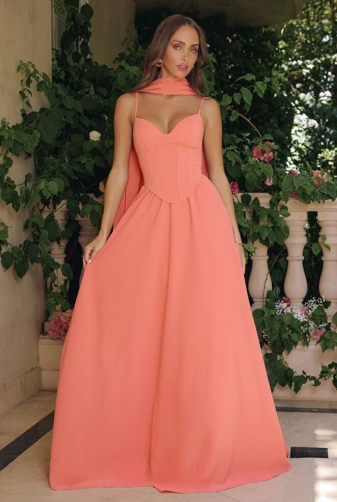 Aurora gown by Ladivine in pastel coral chiffon, featuring a corset bodice, pointed sweetheart neckline, spaghetti straps, lace-up back, and flowing A-line skirt.