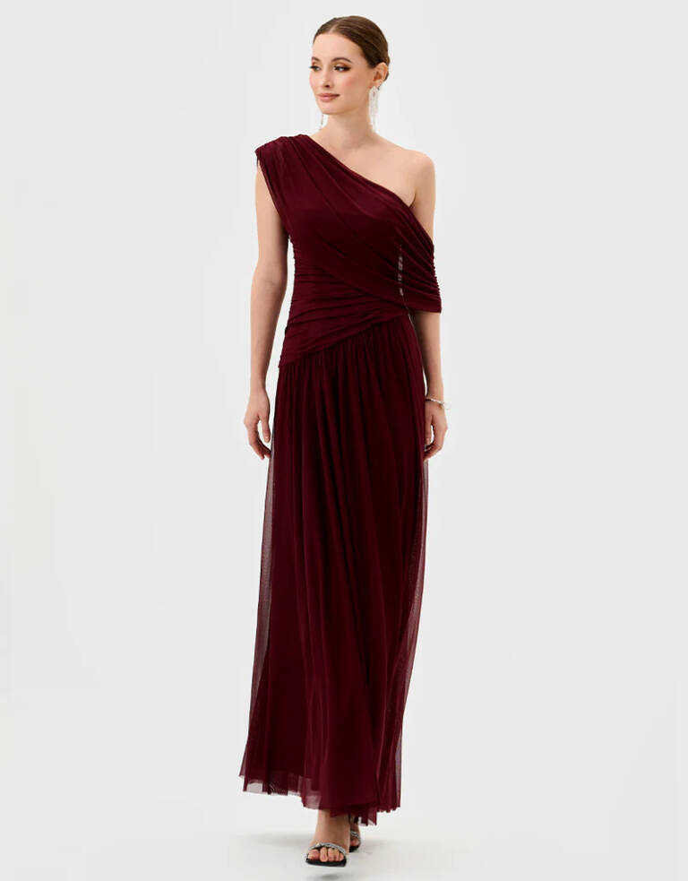 Wine one-shoulder draped maxi dress with ruched bodice, fitted waist and flowing A-line skirt, front view on model.