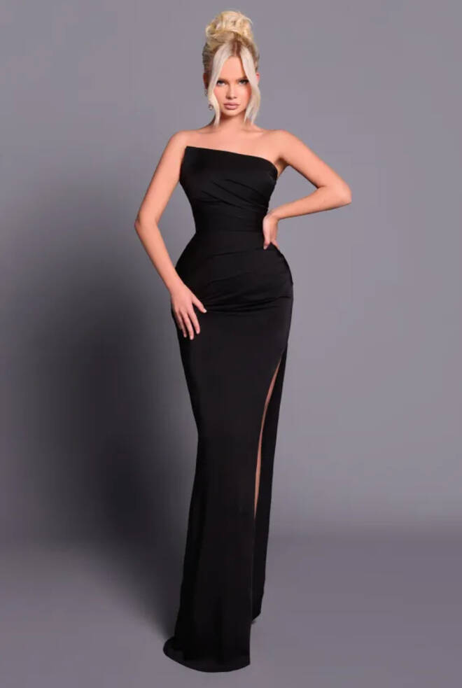 Model wearing Nicoletta NBM2011 full-length Black gown with strapless asymmetrical neckline and thigh-high split.