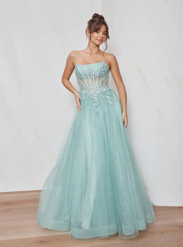 Front view of the Clara Formal Dress PO2678 by Tania Olsen Designs in soft blue glitter tulle with strapless scoop neckline, illusion bodice, lace appliqué, and full A-line skirt.