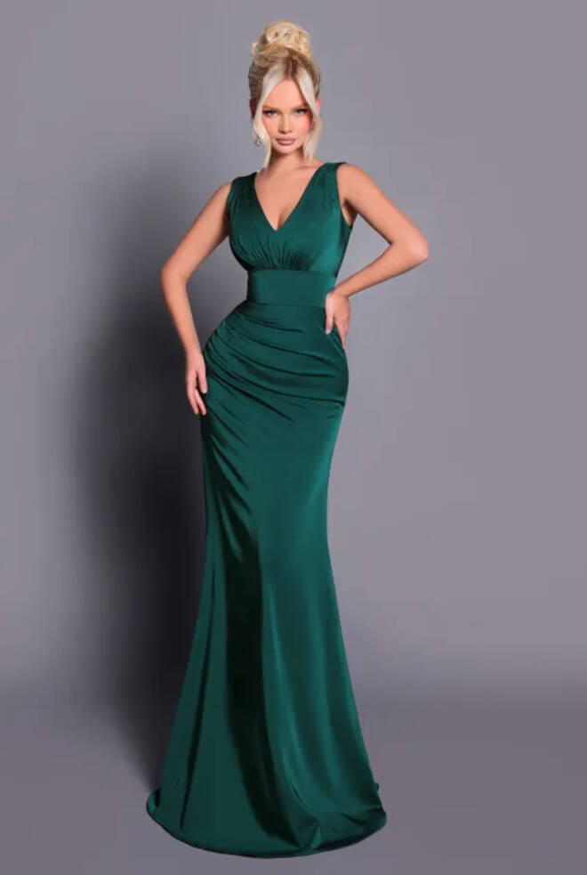 Model wearing Nicoletta NBM2030 dark green soft suiting gown with V-neckline, wide waistband and ruched hip detail, full-length front view.
