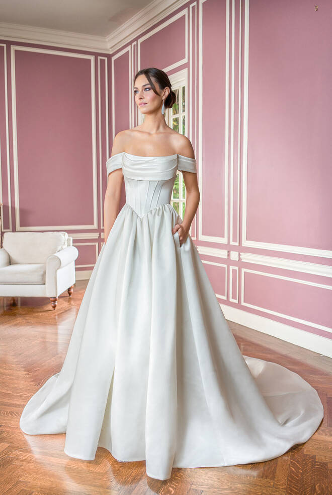 Bride wearing Jayne T282014 by Jasmine Bridal, a couture satin A-line wedding dress with an off-the-shoulder neckline and corset-style bodice.