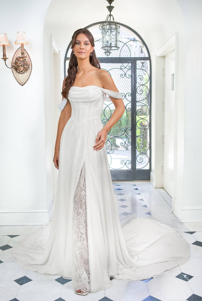 Full front view of Sally T282017 wedding dress with corset-seamed bodice, basque waist, off-the-shoulder sleeves and lace inset slit.