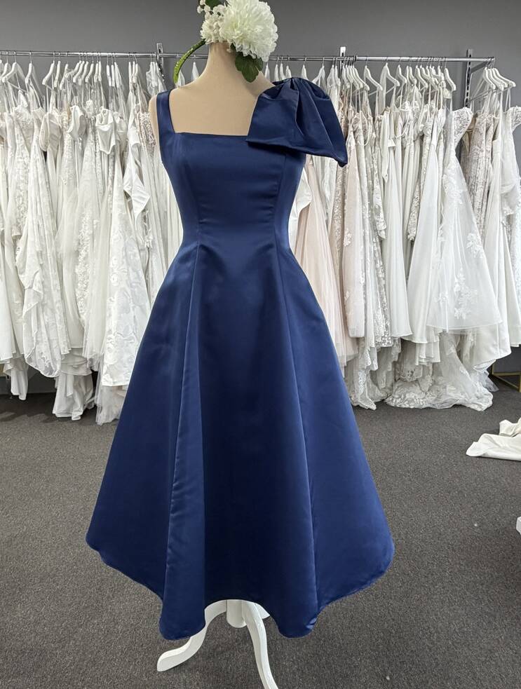 Navy Bariano Brittany BL81D03S midi dress on mannequin, featuring a square neckline, wide straps, statement shoulder bow and A-line skirt.