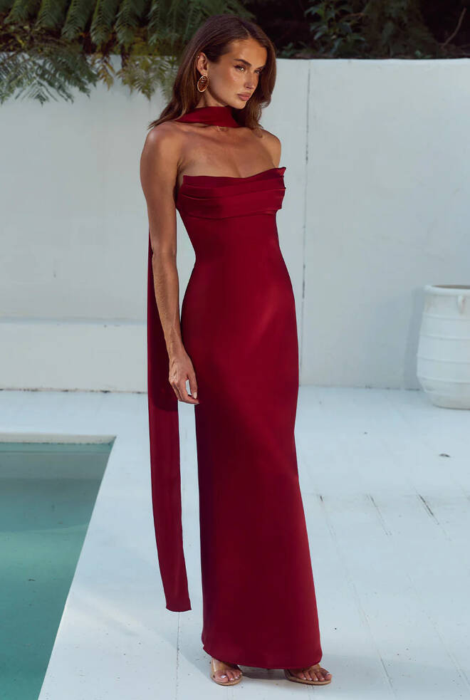 Madeleine Strapless Maxi Dress in Cherry featuring a curved strapless neckline, soft pleated bodice, sleek maxi skirt and matching neck scarf detail.