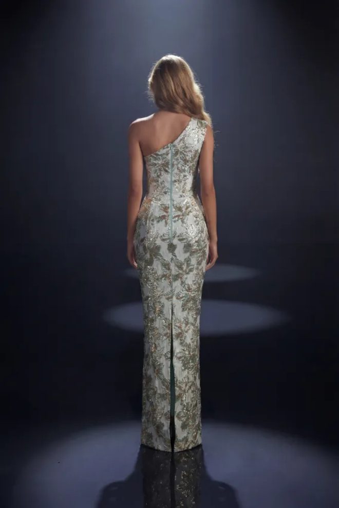 Back view of Nicoletta NC4014 sage floral formal gown with asymmetric shoulder detail, centre-back zip and skirt split.