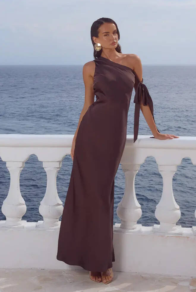 Front view of Viola One Shoulder Maxi Dress in bitter chocolate with asymmetrical neckline, shoulder tie detail and elegant fitted maxi silhouette.