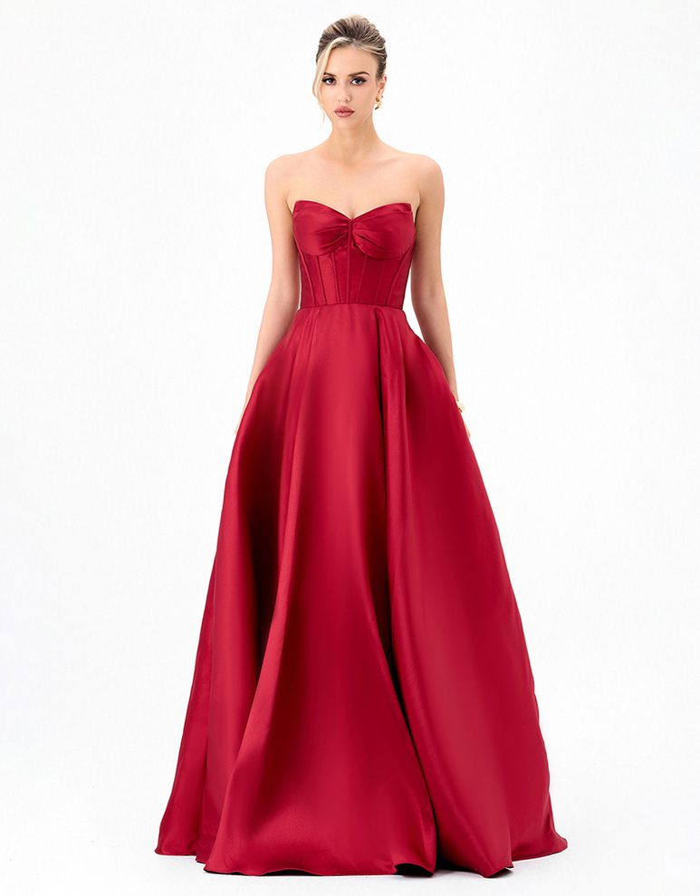 Deeba B84D0424 red strapless formal gown with a structured corset bodice, pleated bust and full ball gown skirt.